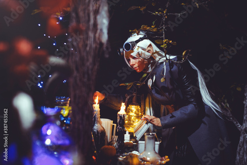 Halloween elf with magic magic in the dark forest. © lanarusfoto