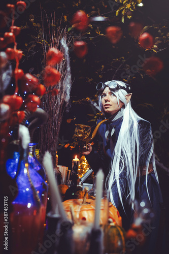 Halloween elf with magic magic in the dark forest.