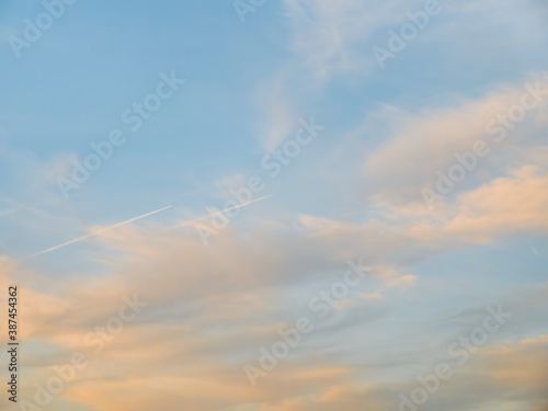 Fototapeta Naklejka Na Ścianę i Meble -  Contrail left by an airplane on a dramatic sky at sunset.