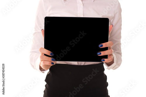 Close-up shot of a girl holding a tablet in her hands. Girl holding tablet with blank space for logo and lettering.