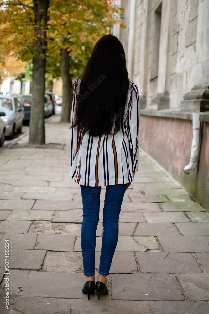 Alone woman staying looking at the city. Young girl who stay back to camera. View from back. Staying back Alone woman staying looking at the city. Young girl who stay back to camera. View from back. Staying back