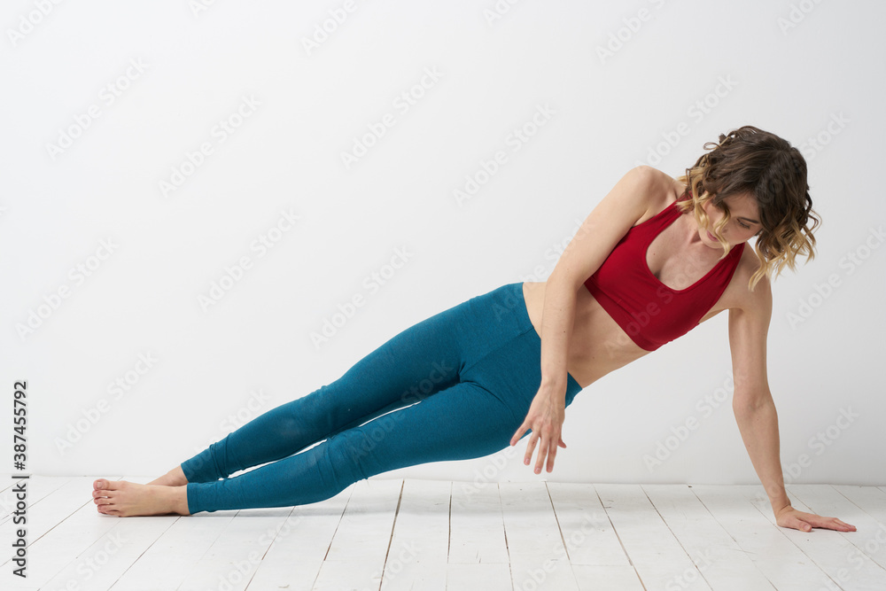 woman in leggings is engaged in gymnastics in a light room slim figure fitness sport woman in leggings is engaged in gymnastics in a light room slim figure fitness sport