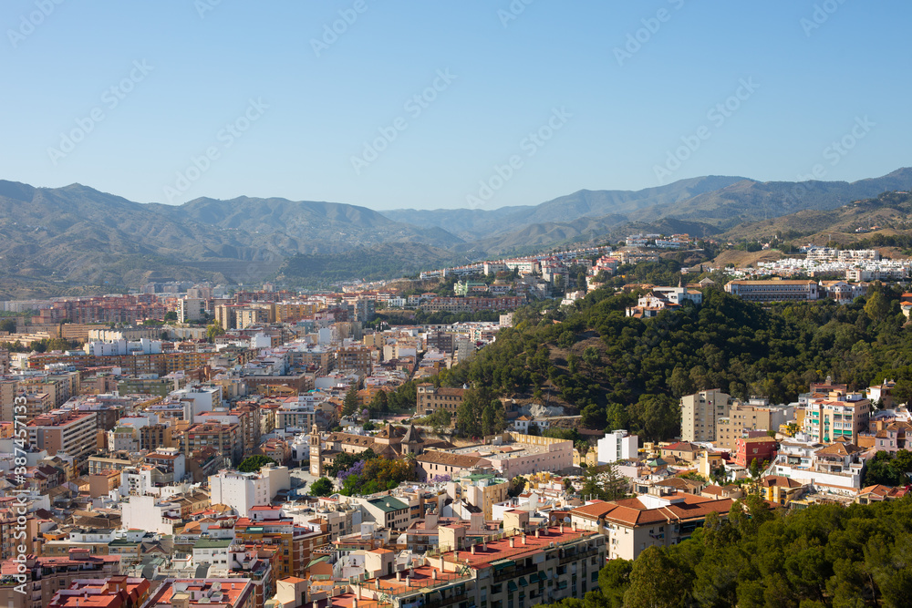 View from the mountain in the city of Malaga, Spain. There are many houses and roads in the background.