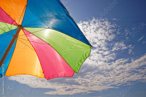 rainbow umbrella on the beach