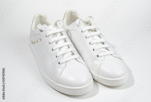 White sneakers on white background including edging