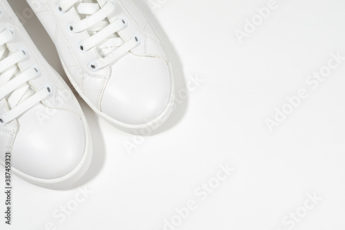 White sneakers on white background including edging