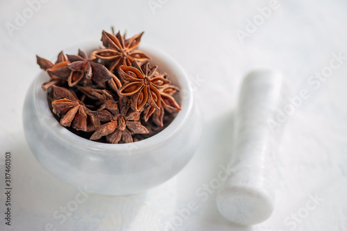 star anise in a mortar and pestle is ready to be crushed. Grinding of spices. Close up. Copy space