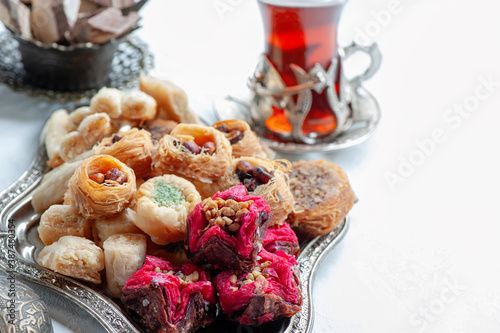 Arabic, Lebanese and Turkish sweets kataifi and kanafeh, a Traditional Eastern dessert made of thin dough with syrup , nuts and seeds. Close up photo