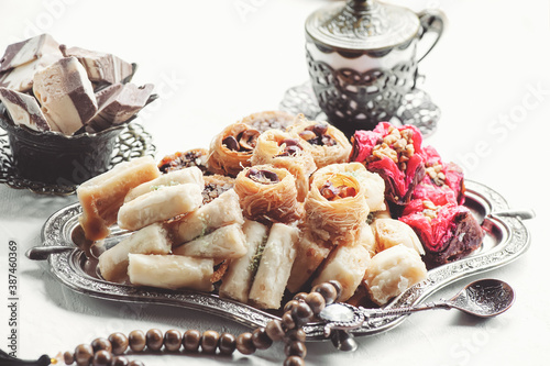 Arabic, Lebanese and Turkish sweets kataifi and kanafeh, a Traditional Eastern dessert made of thin dough with syrup , nuts and seeds. photo