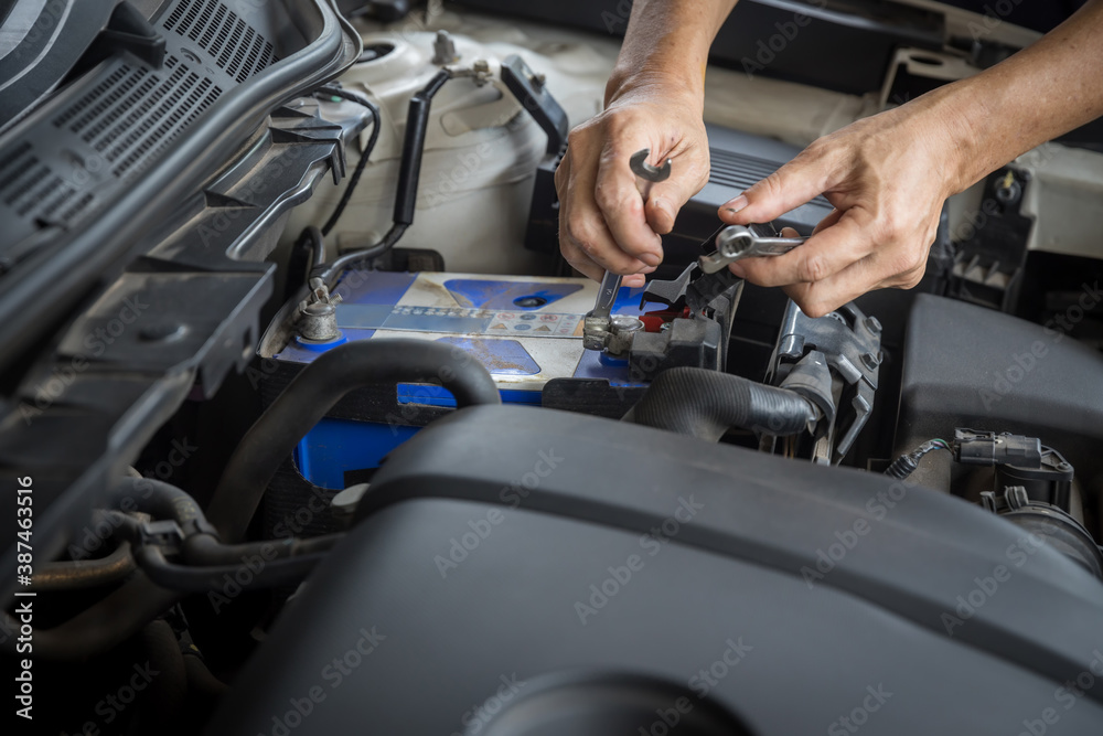 Engine engineer is replacing  car battery because car battery is depleted. concept car maintenance And the cost of car care.
