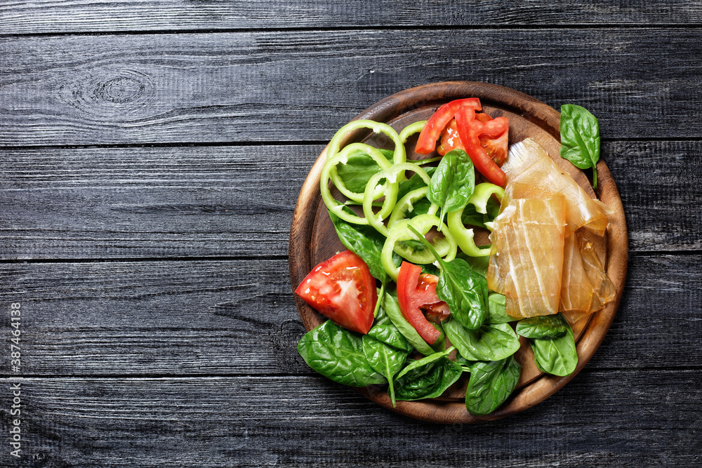 Spinach, pepper, dried tuna and tomato, copy space Spinach, pepper, dried tuna and tomato, copy space