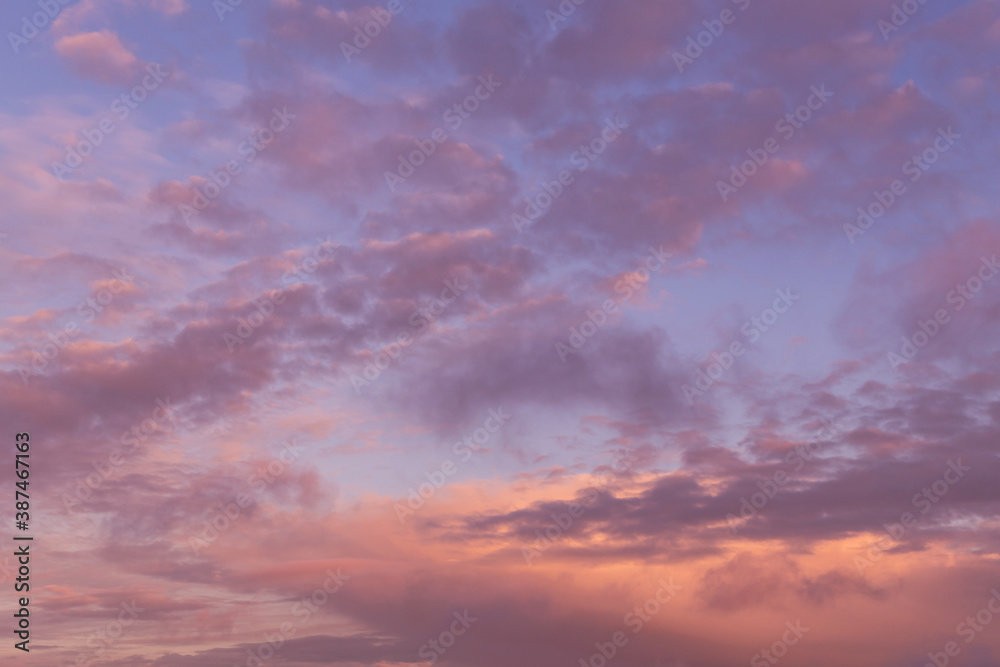 Dramatic soft sunrise, sunset pink violet orange blue sky with clouds background texture