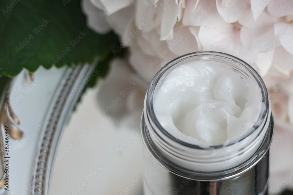 face cream, white, against flowers face cream, white, against flowers