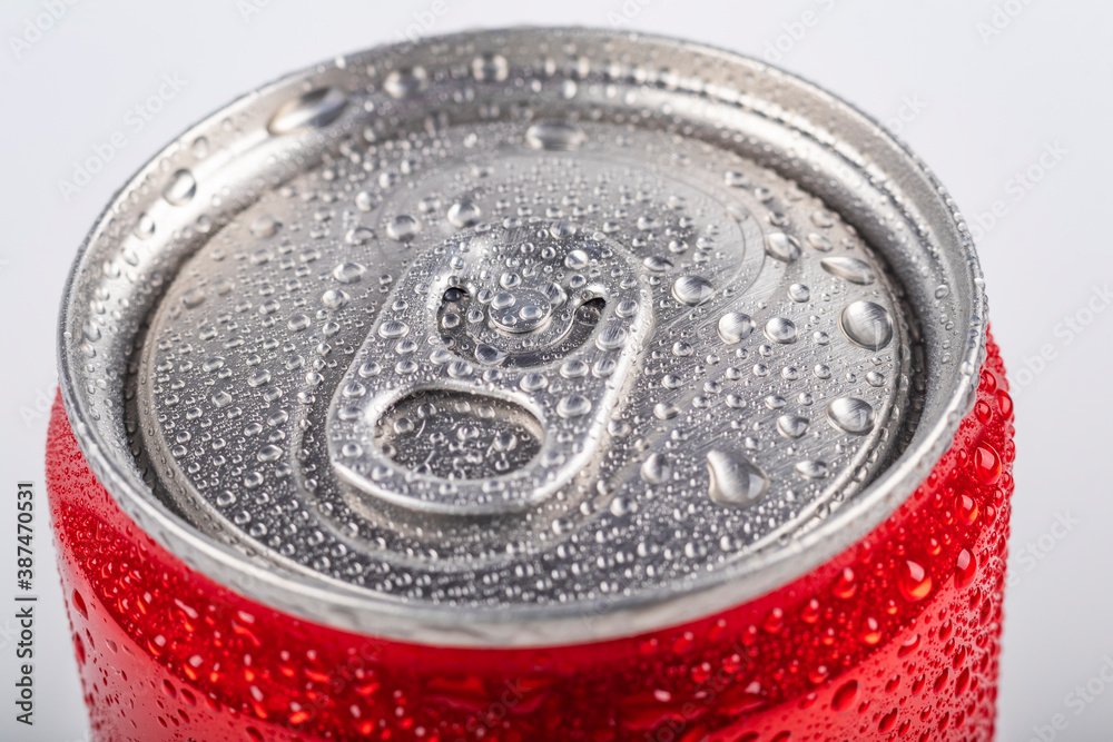 Studio lighting. aluminum red can with small drops of water on it. Chilled. The cover is open. On white background. Studio lighting. aluminum red can with small drops of water on it. Chilled. The cover is open. On white background.