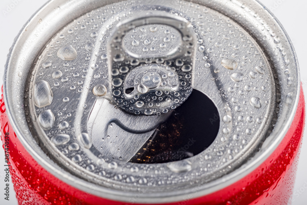 Studio lighting. aluminum red can with small drops of water on it. Chilled. The cover is open. On white background. Studio lighting. aluminum red can with small drops of water on it. Chilled. The cover is open. On white background.