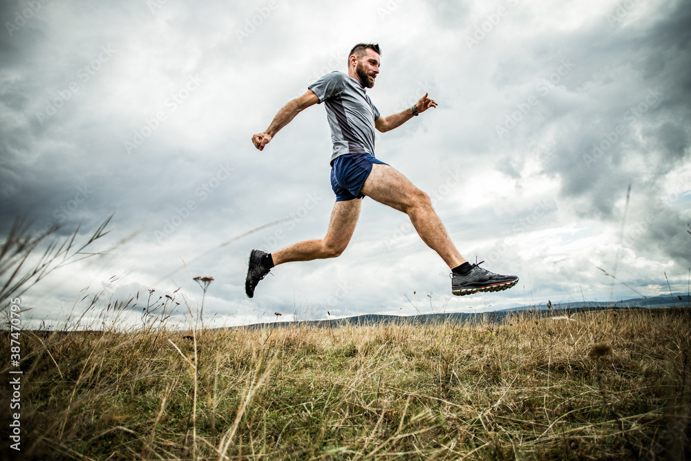 handsome trail runner running in nature handsome trail runner running in nature