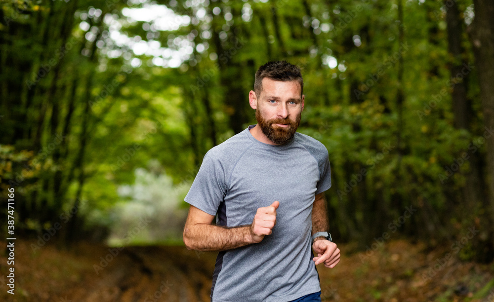handsome trail runner running in nature handsome trail runner running in nature
