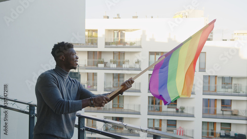 Black man waving rainbow flag. Sexual identity and equal treatmant concept. High quality photo photo