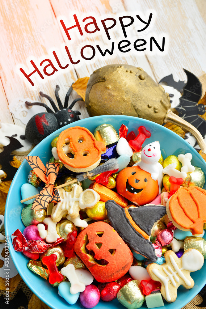candy bowl of chocolates and sweets, Halloween Jack o Lantern cookies - Trick or Treat Halloween card background 