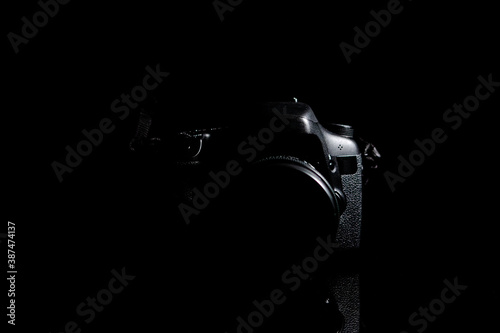 Camera on black background with ground reflection