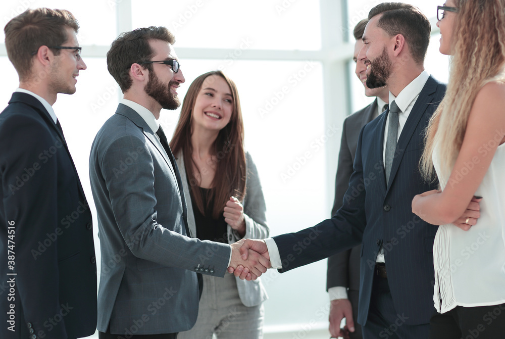 smiling business partners shaking hands smiling business partners shaking hands