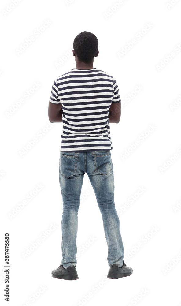 rear view. a young man reading something on a white wall rear view. a young man reading something on a white wall