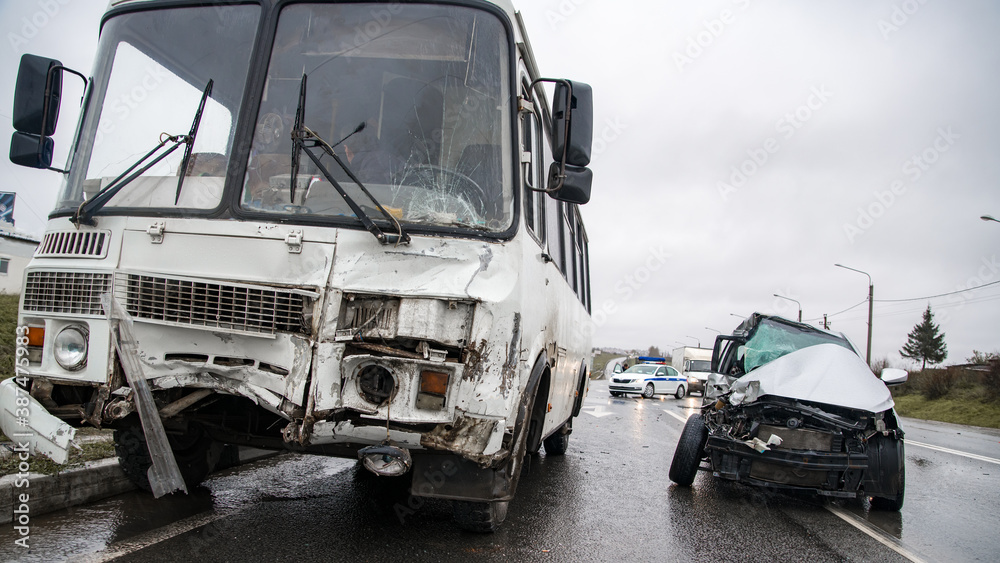 accident on a slippery road in a bus and car at shallow depth of field