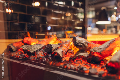 Electric log fireplace. Restaurant showcase decorated with artificial heater. Exterior design