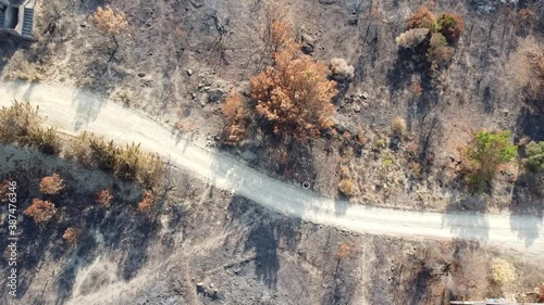 Overflight with a drone over a burnt forest landscape on the Turkish Aegean Sea. Ashes, destruction and burnt areas can be seen from a bird's eye view photo