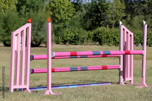  Obstacles poles barriers for jumping horses as a background
