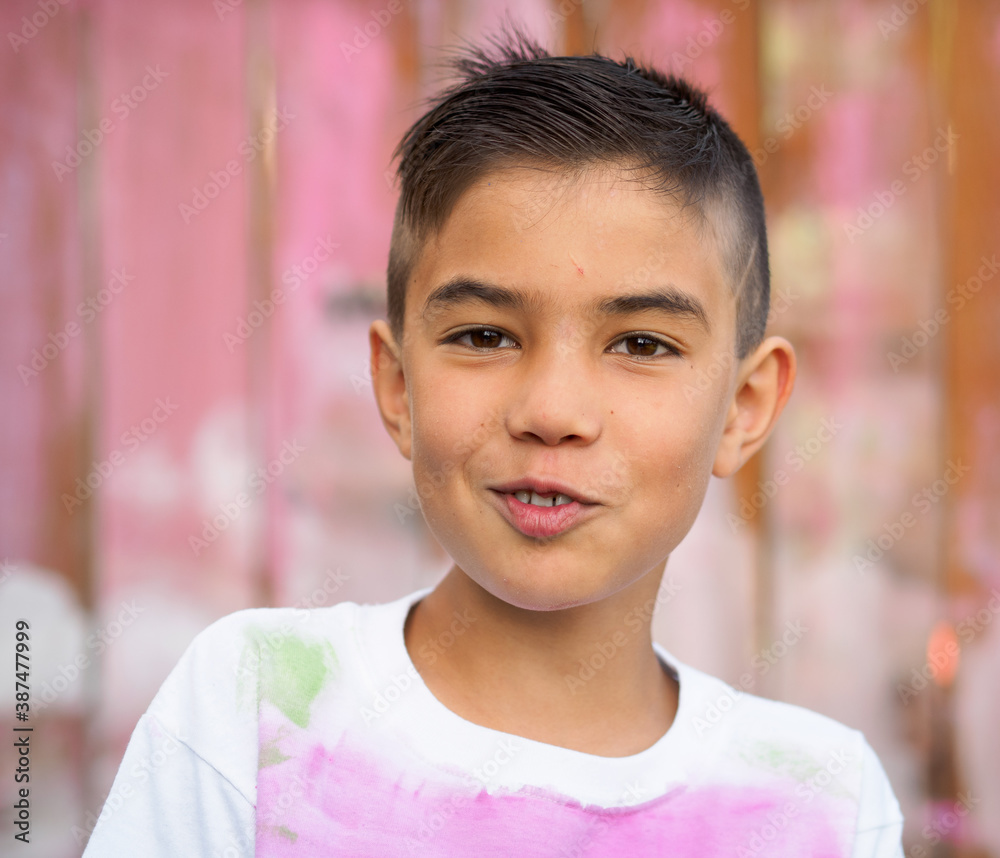cheerful boy in hand painted t-shirt on painted fence background cheerful boy in hand painted t-shirt on painted fence background