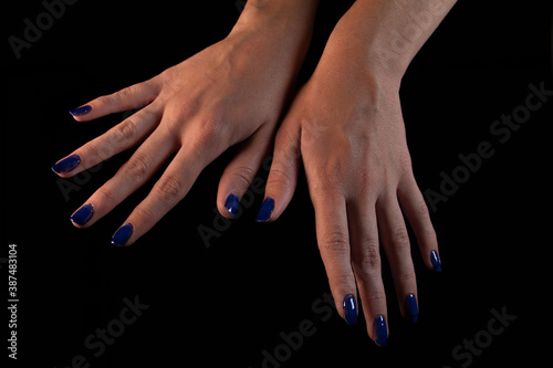 Butterfly-shaped female hands with a dark background