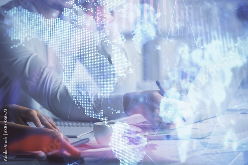 Double exposure of man and woman working together and financial graph hologram. Business concept. Computer background.