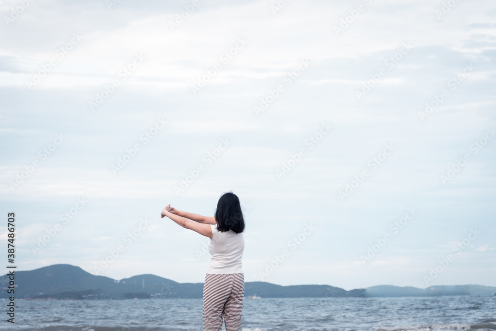 Asian woman stretch body and little excercise with on the beach. concept for holiday vacation and relaxing. Asian woman stretch body and little excercise with on the beach. concept for holiday vacation and relaxing.