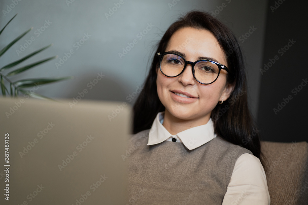 Manager office employee young woman with glasses brunette Caucasian appearance. records important events projects and plans to promote the company's new website in a laptop computer. Manager office employee young woman with glasses brunette Caucasian appearance. records important events projects and plans to promote the company's new website in a laptop computer.