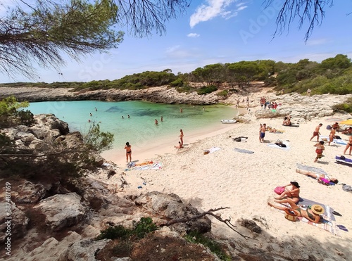 Playa Cala Des Talaier famous paradise beach with turquoise water and pine forests on south coast of Menorca Island, Balearic Islands, Spain photo