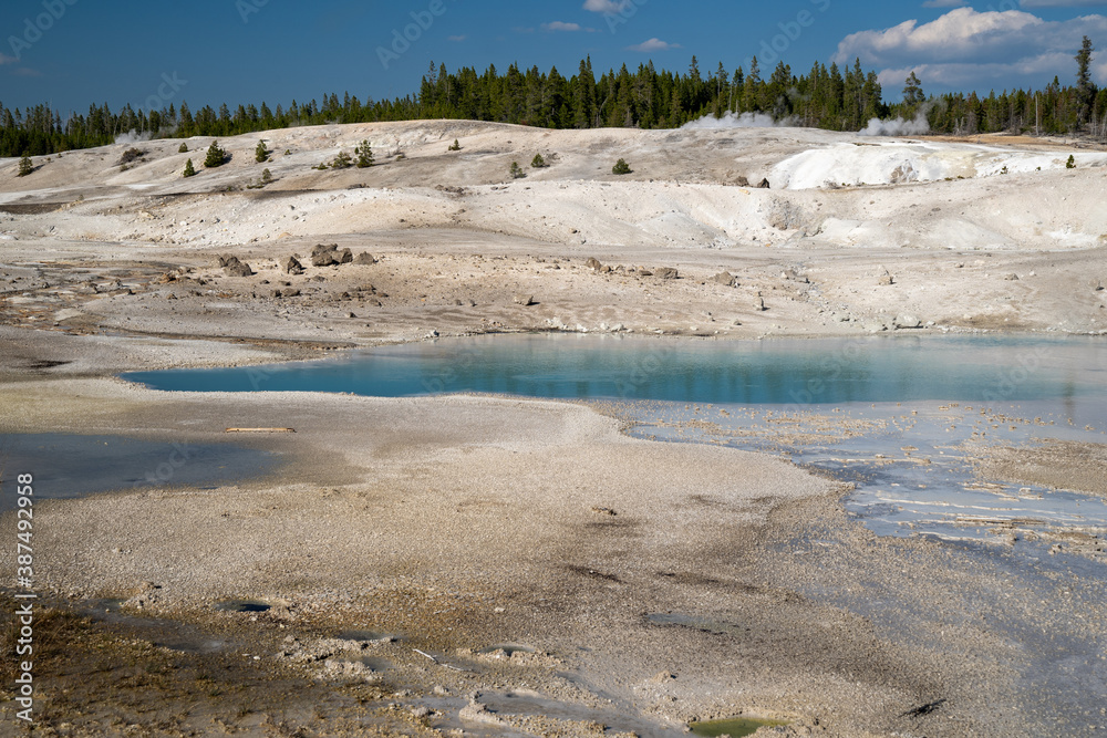 Beautiful milky teal water in a hot spring along the porcelain basin trail, in Yellowstone National Park - Norris Geyser Basin area Beautiful milky teal water in a hot spring along the porcelain basin trail, in Yellowstone National Park - Norris Geyser Basin area