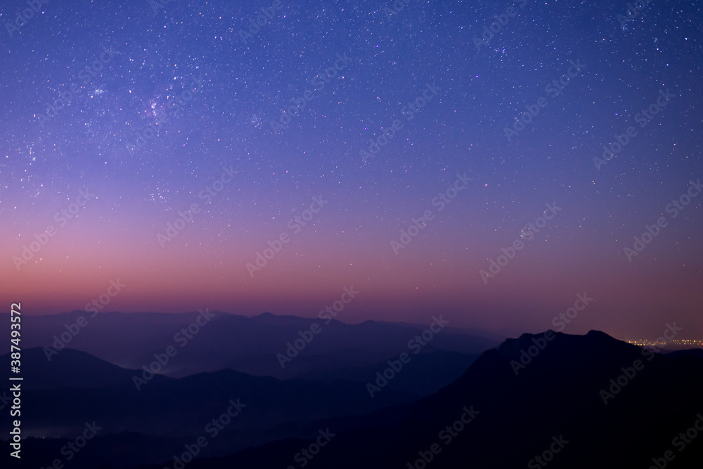 Night landscape with colorful star and milky way and beautiful twilight sky before sunrise over the mountain.