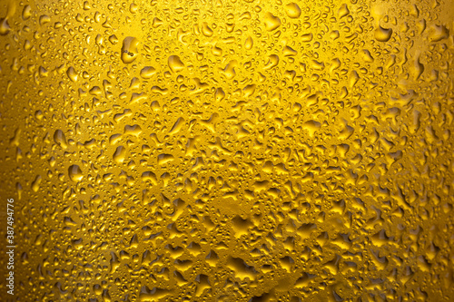 Closeup of cold lager beer background with water drops.