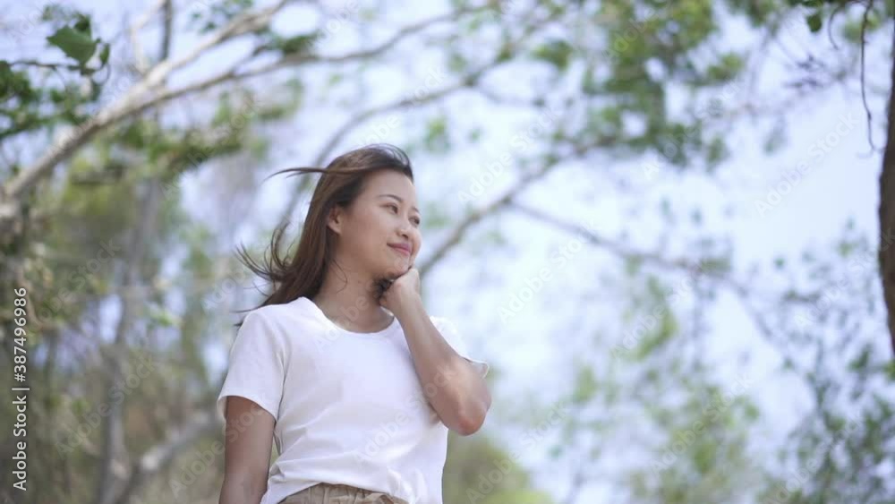 Slow motion portrait of Happy young attractive Asian woman tourist relaxing with beautiful nature on island beach. Smiling pretty girl enjoy and having fun outdoor lifestyle in summer holiday vacation Slow motion portrait of Happy young attractive Asian woman tourist relaxing with beautiful nature on island beach. Smiling pretty girl enjoy and having fun outdoor lifestyle in summer holiday vacation
