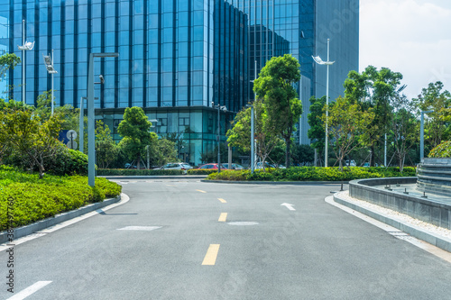 clean asphalt road through office block area, suzhou, china