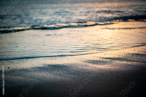 Quiet Water, Ocean ripples on the ocean surface at dusk or dawn with the reflection of a sunset or sunrise warm light color. 