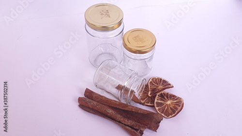 cinnamon sticks and dried lemons in  jars