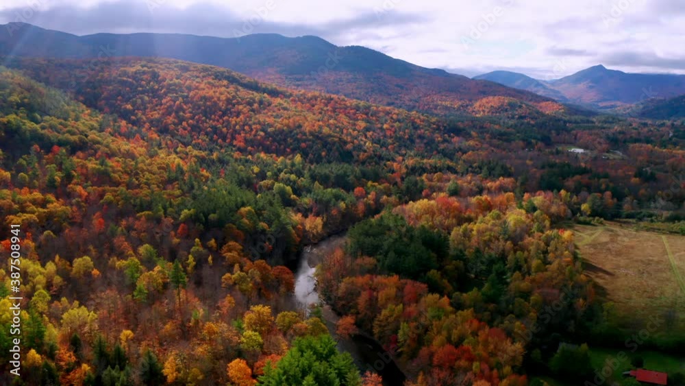 Aerial flythrough of Winding River Through Autumn Trees with Fall Colors in New England