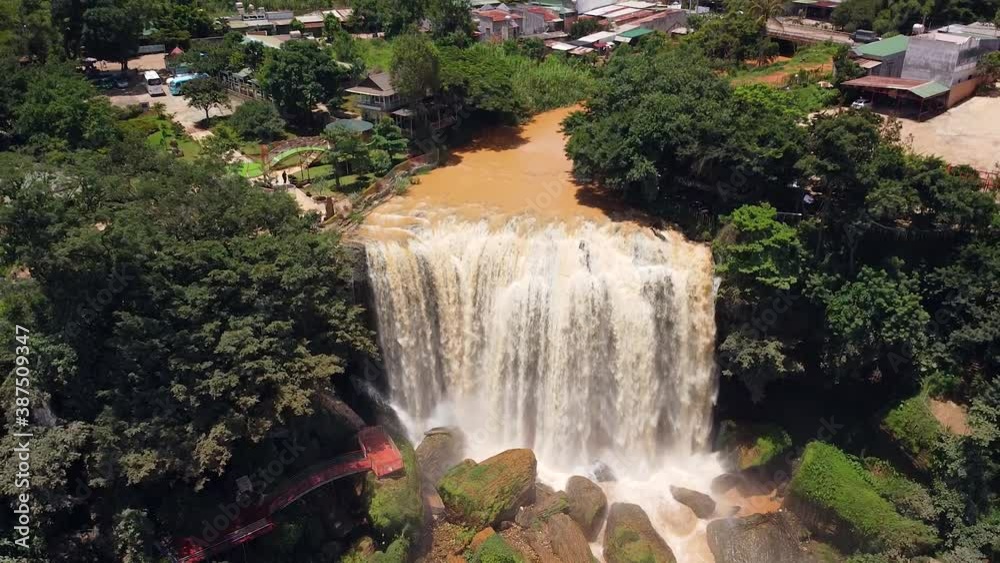 Aerial view of huge waterfall near a countryside town in Asia. Aerial view of huge waterfall near a countryside town in Asia.