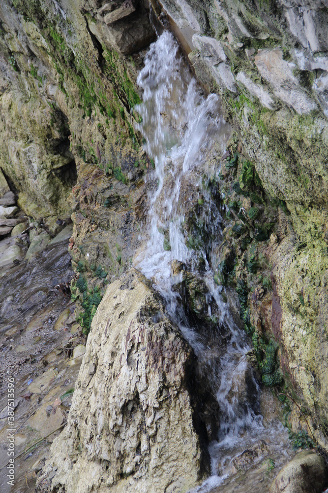 small waterfall from the wall and cliff