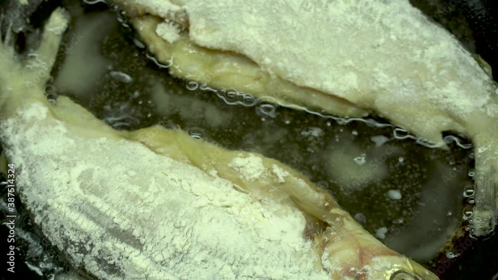 fish in batter with a crispy crust is fried and cooked in a pan with oil. Recipe for traditional fried fish cooking fish in batter with a crispy crust is fried and cooked in a pan with oil. Recipe for traditional fried fish cooking
