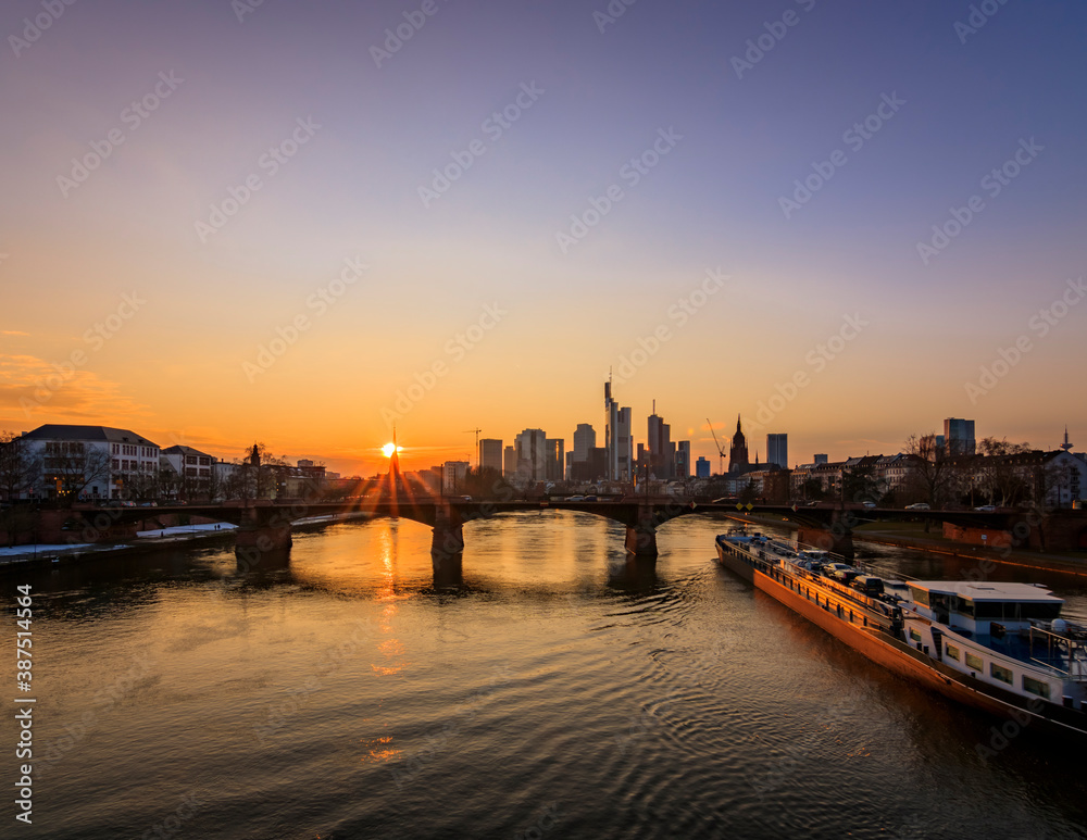 Frankfurt skyline in Germany photographed from the main river. Reflection in the water and a great city view at sunset