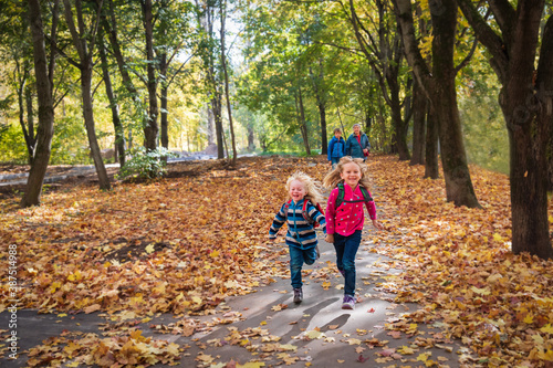 happy kids with grandmother walk in autumn nature