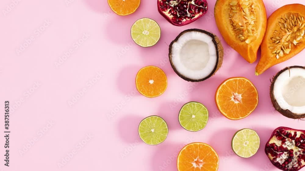 Slices of fresh ripe fruits appear on right side of pastel pink theme. Stop motion Slices of fresh ripe fruits appear on right side of pastel pink theme. Stop motion